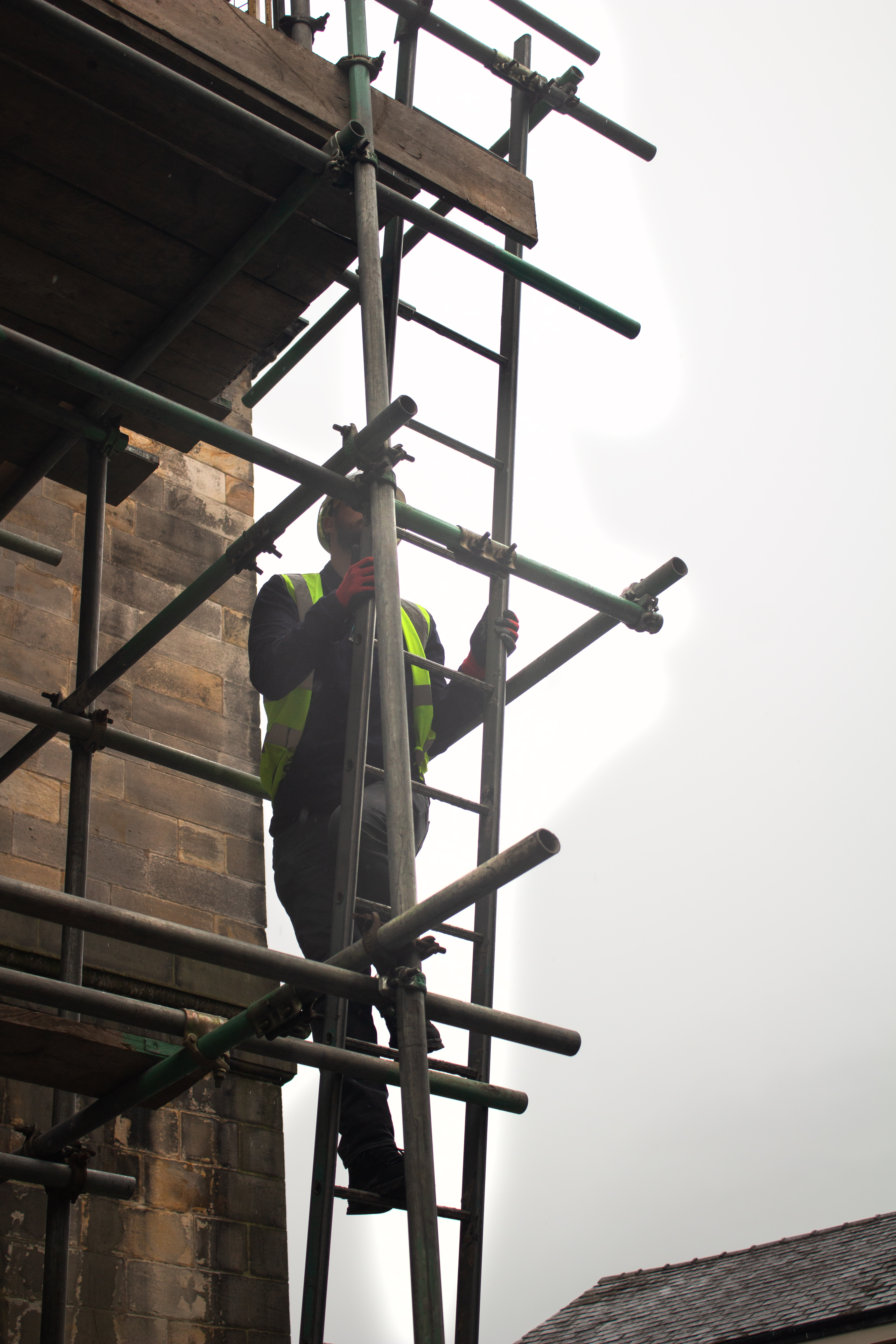 Apprentice ascending the scaffolding.